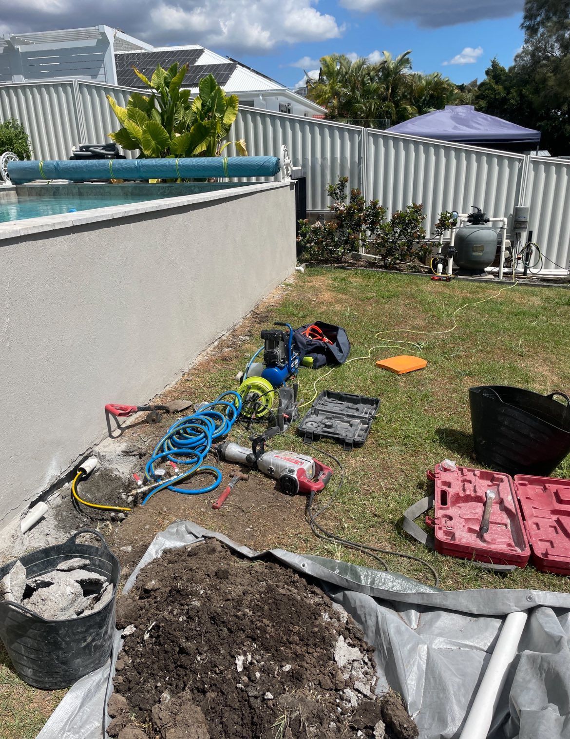Backyard With Tools and Equipment Near a Pool. Construction or Repair Work in Progress — Leak N Pool In Southport, QLD