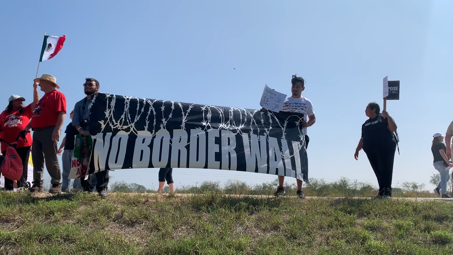 Protesters march with banner