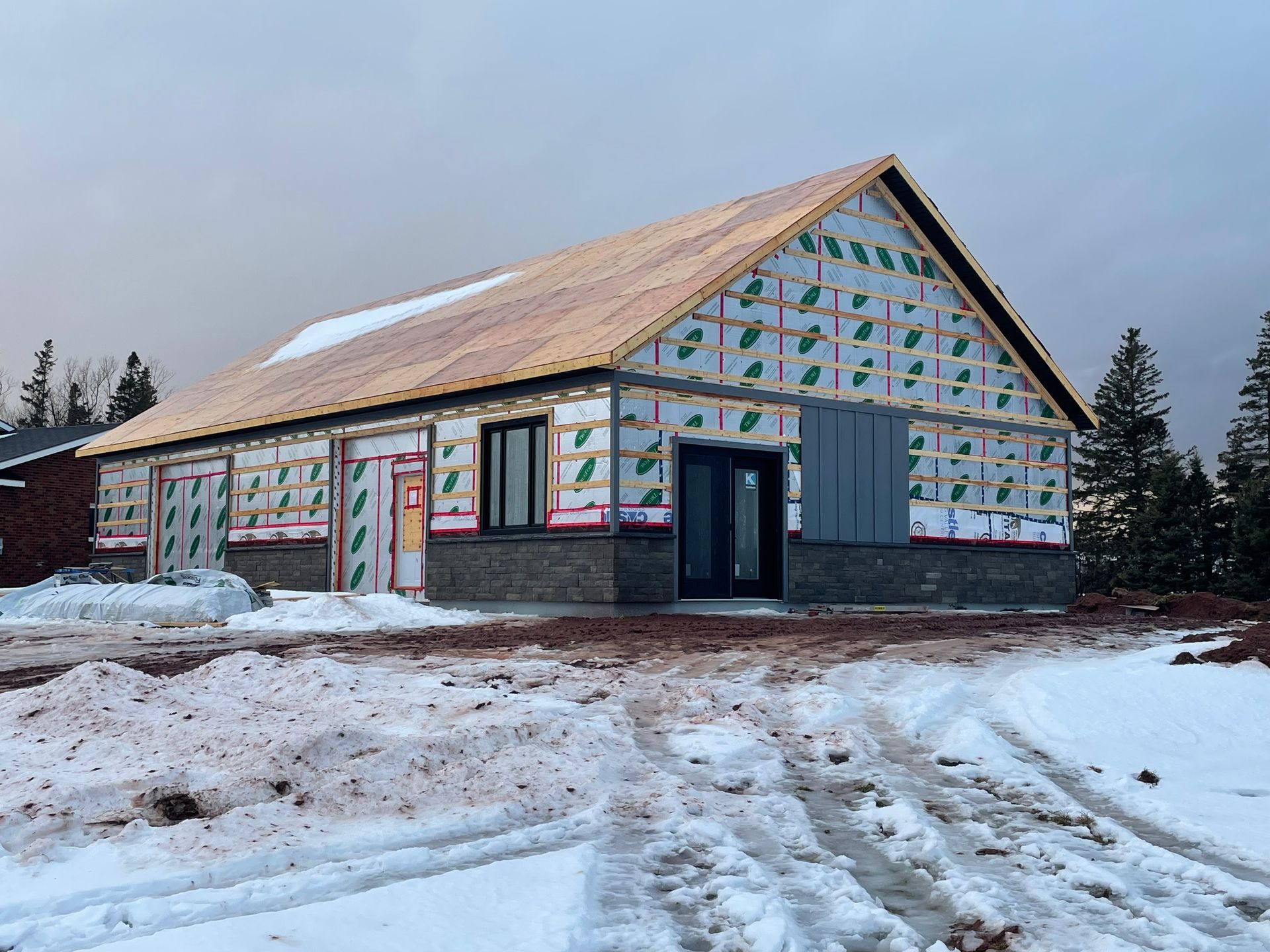 A house is being built in the snow in a field.