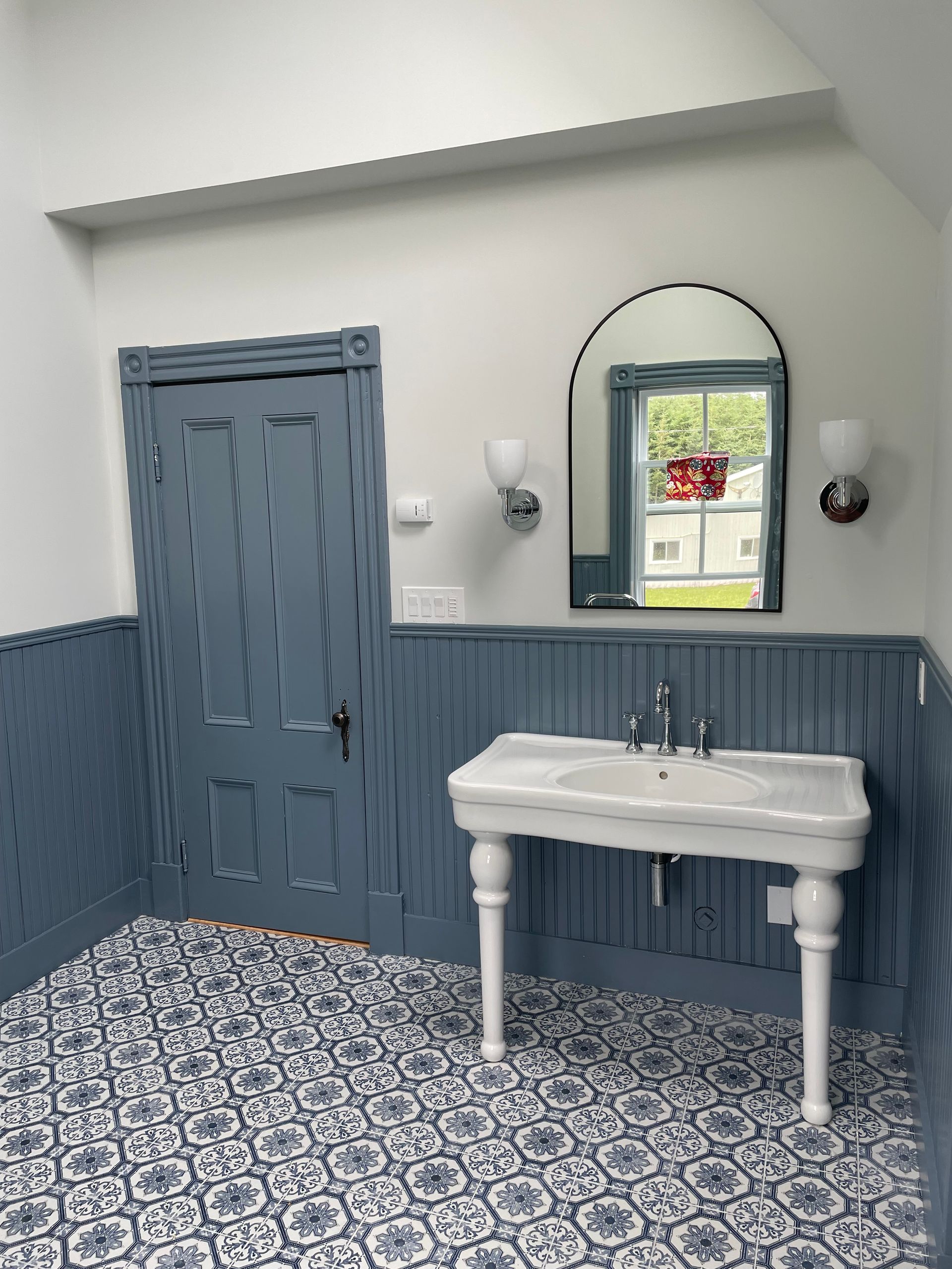 A bathroom with a sink and a mirror on the wall