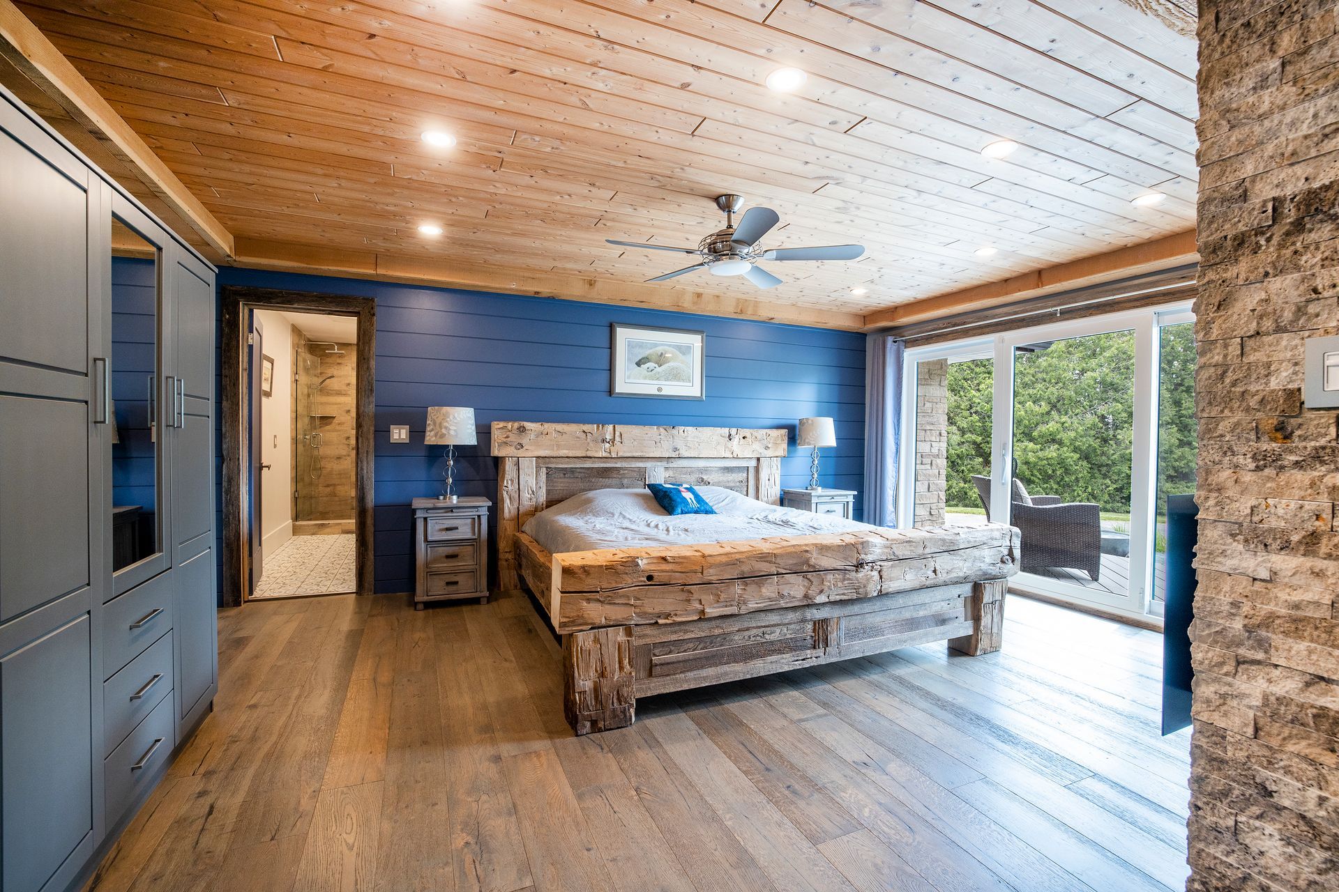 A bedroom with a large bed and a ceiling fan.