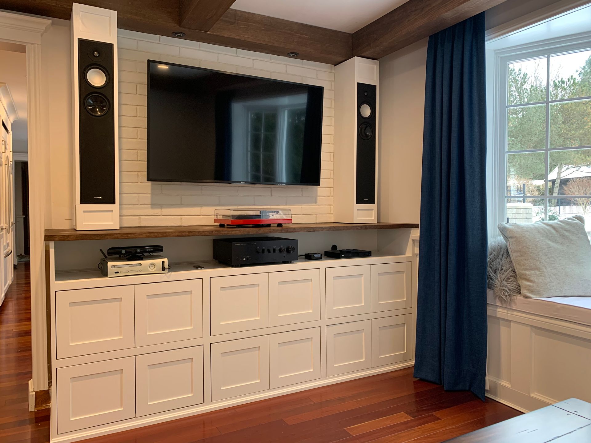 A living room with a large flat screen tv mounted on the wall.