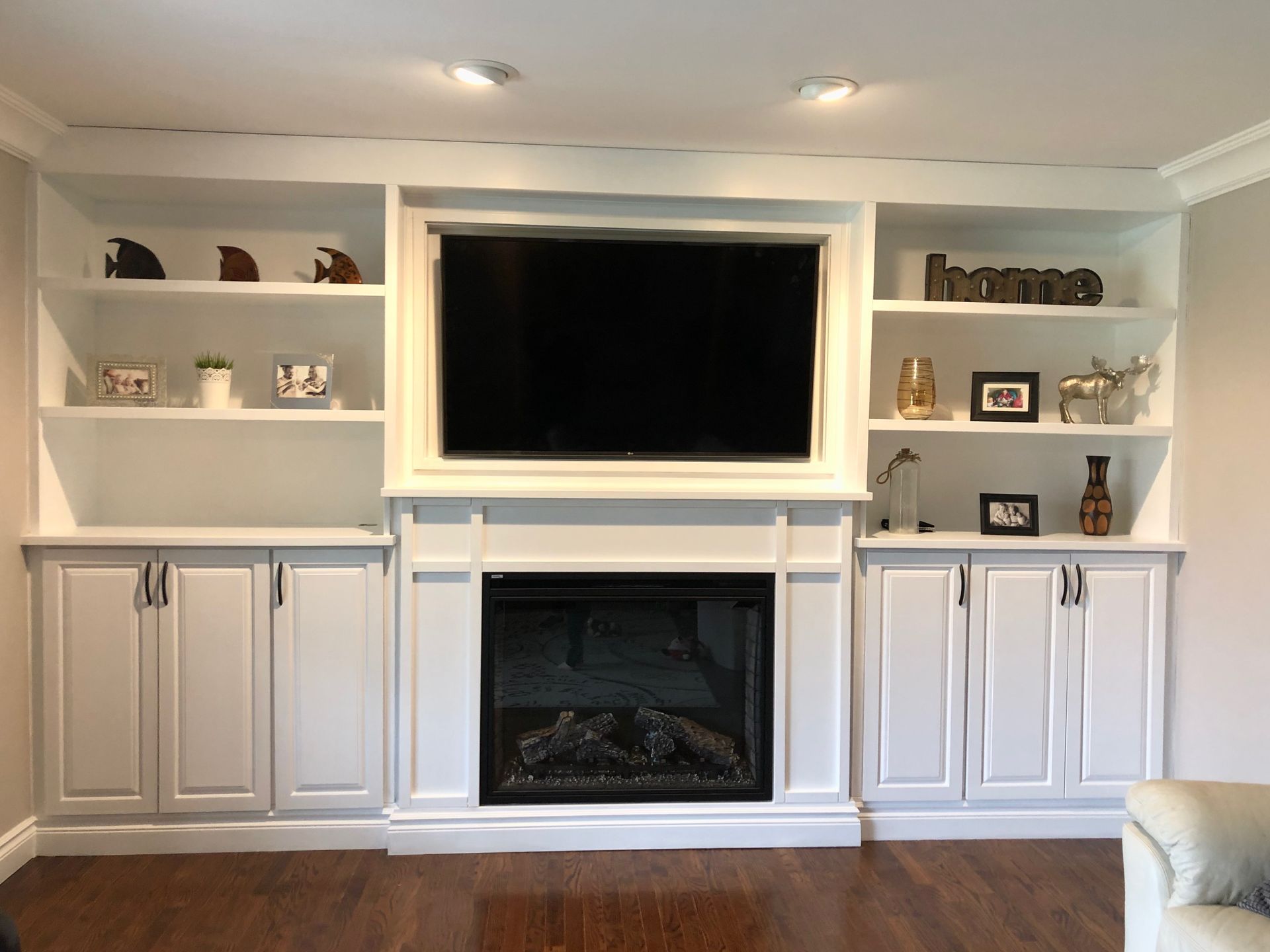 A living room with a fireplace and a flat screen tv.