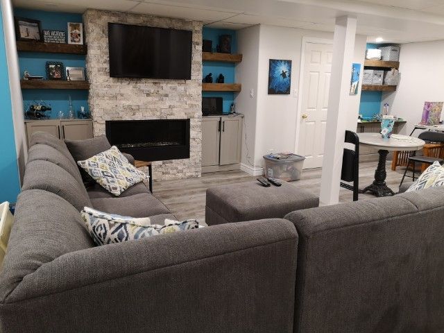 A living room with a couch and a fireplace