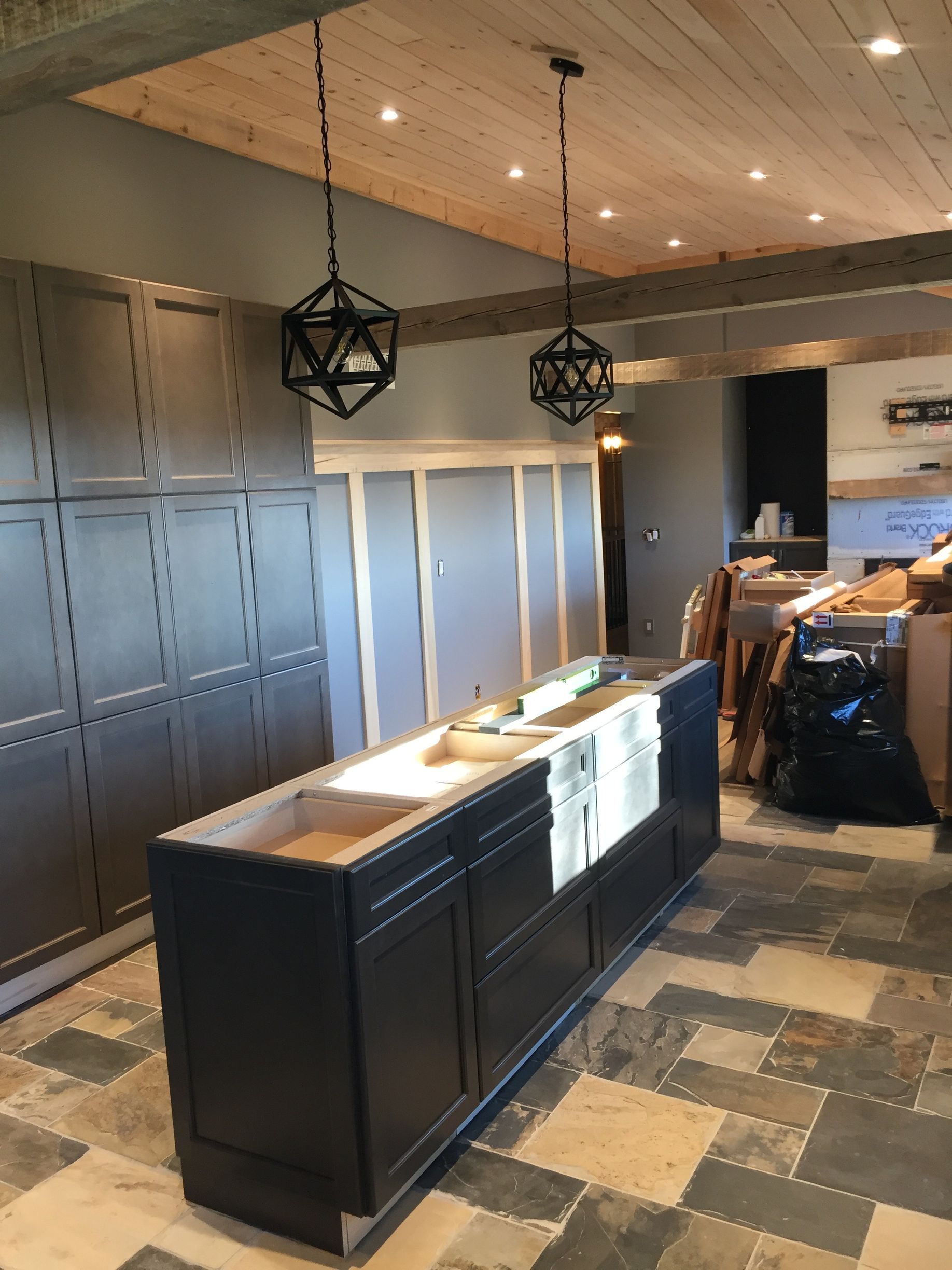 A kitchen under construction with a large island in the middle