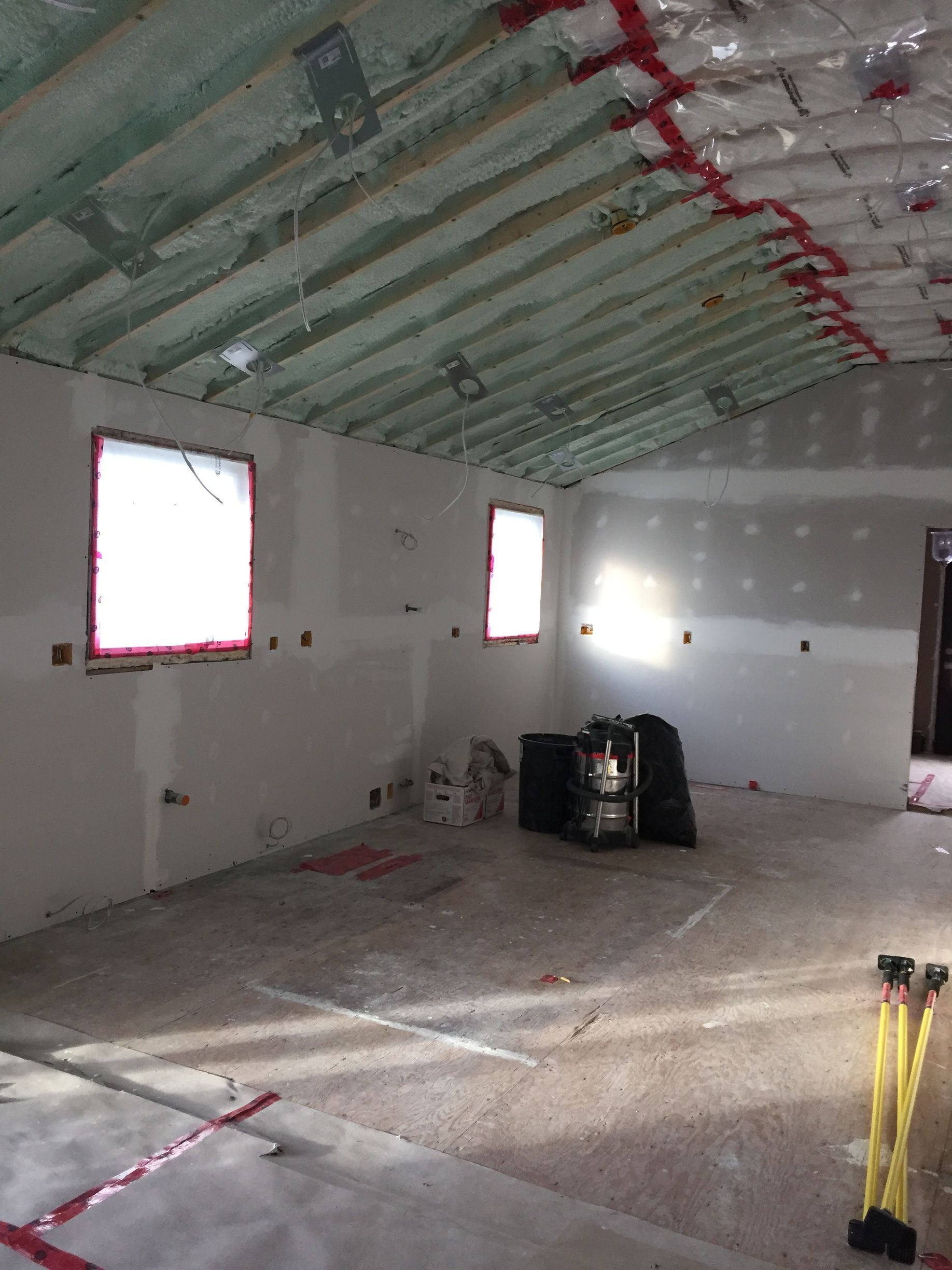An empty room with a green ceiling and white walls