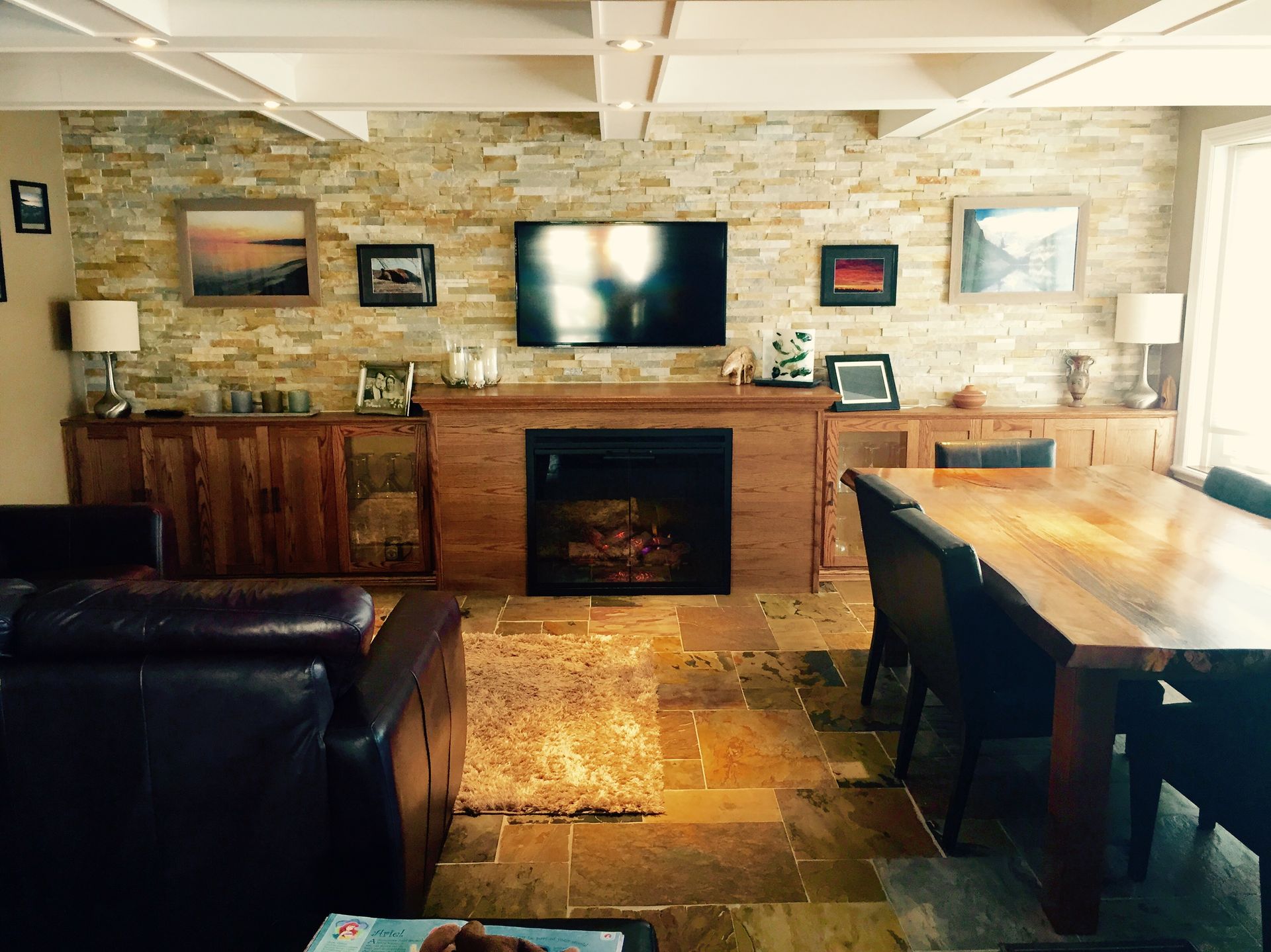 A living room with a fireplace and a flat screen tv