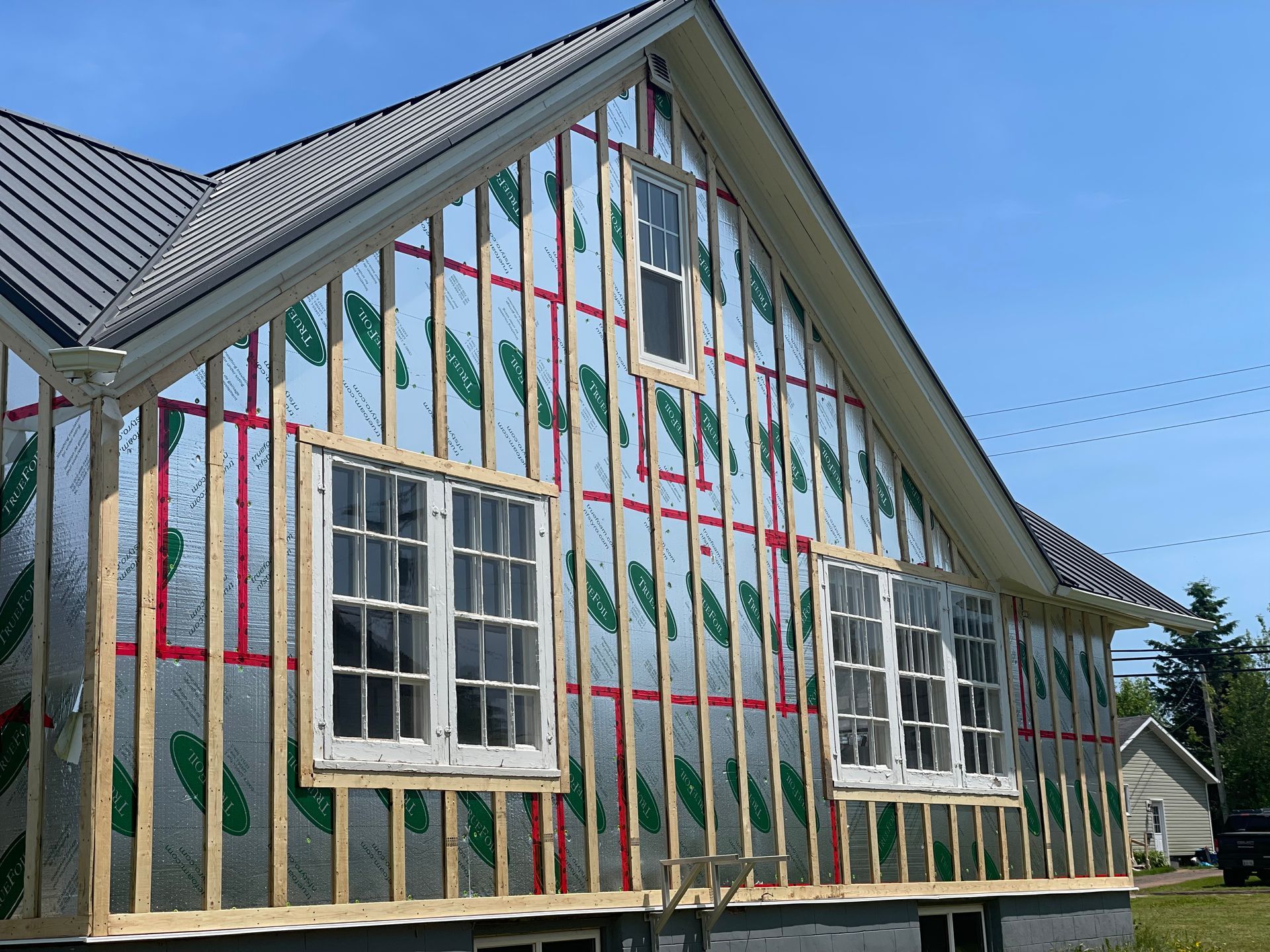 A house is being built with a lot of windows.