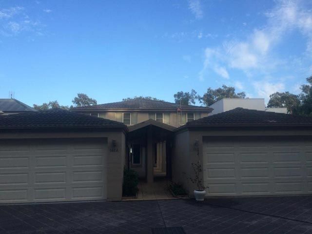 A House with two Garages and a blue sky in the Background — Roof Repairs in Maitland, NSW