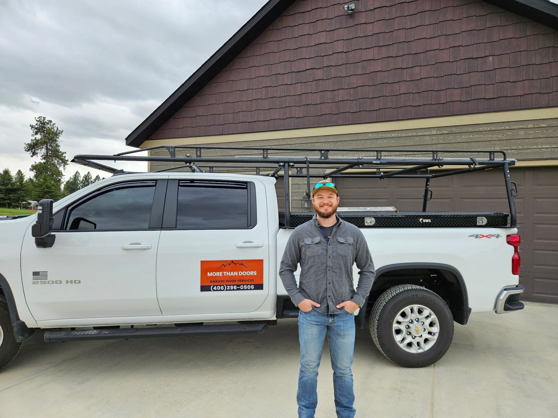 A man is working on a garage door in a garage.
