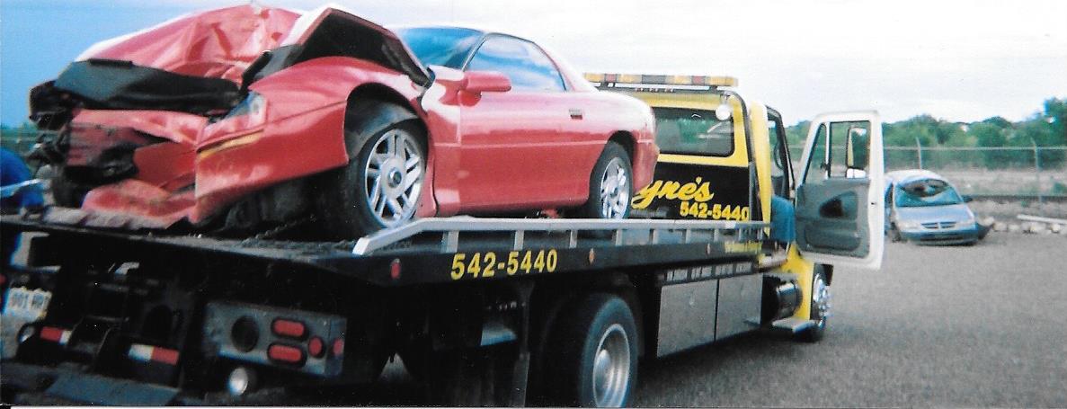 Wrecked Car on the Back of Tow Truck - Accident Towing and Roadside Assistance in Pueblo, CO