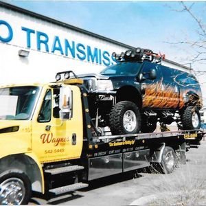 SUV on Tow Truck - Tow Truck Services and Equipment Hauling in Pueblo,CO and the Surrounding Area