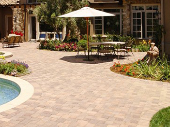 A patio with a table and chairs and an umbrella