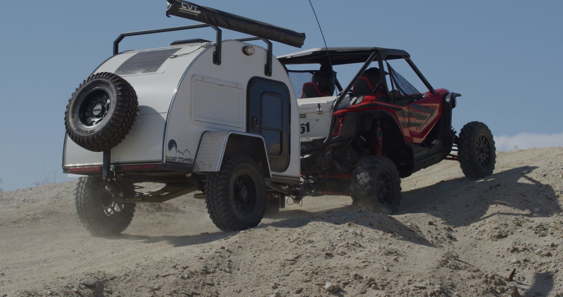 parked white off-road camping trailer