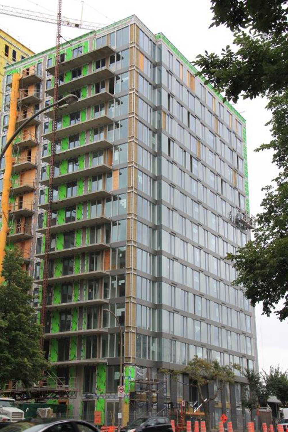 A tall building with a lot of windows is under construction