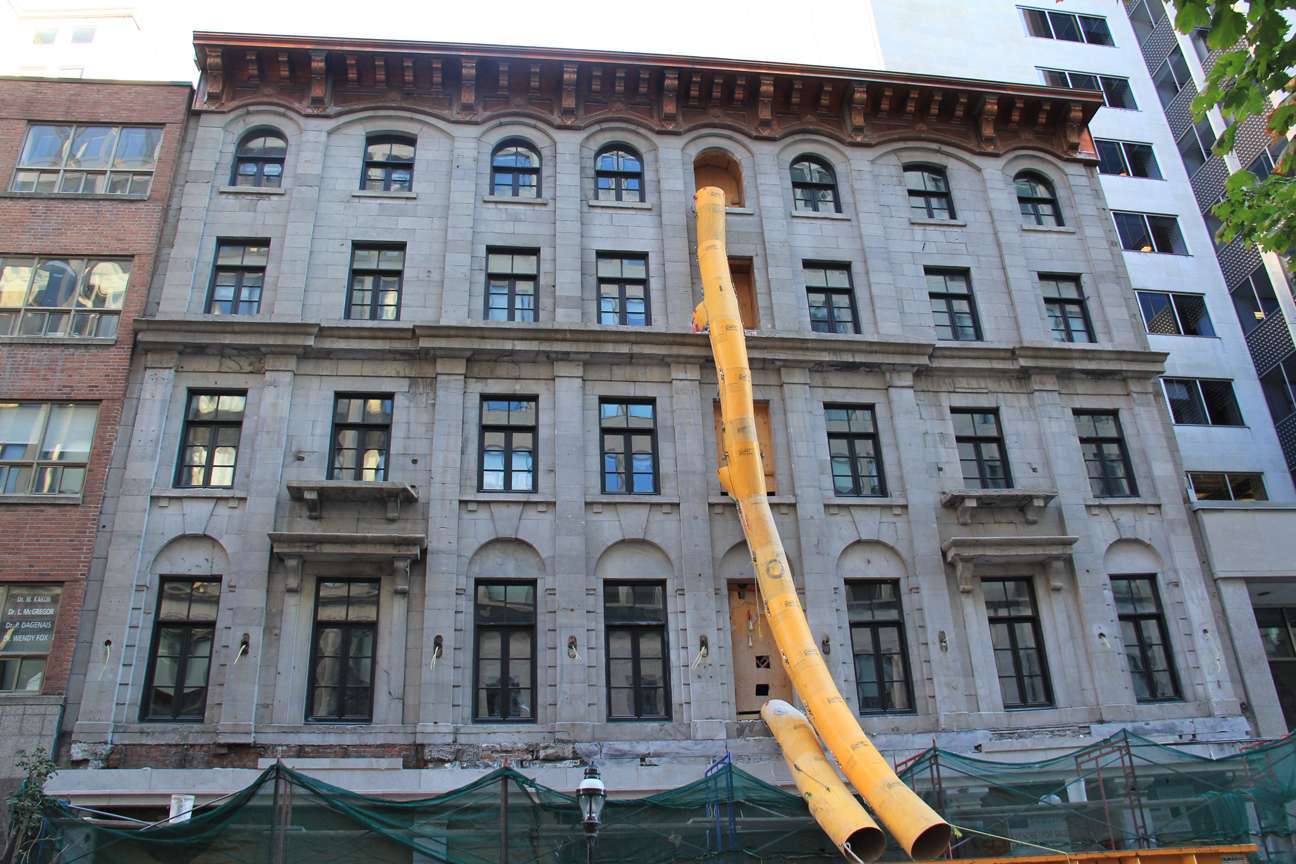 A large building with a yellow pipe coming out of it