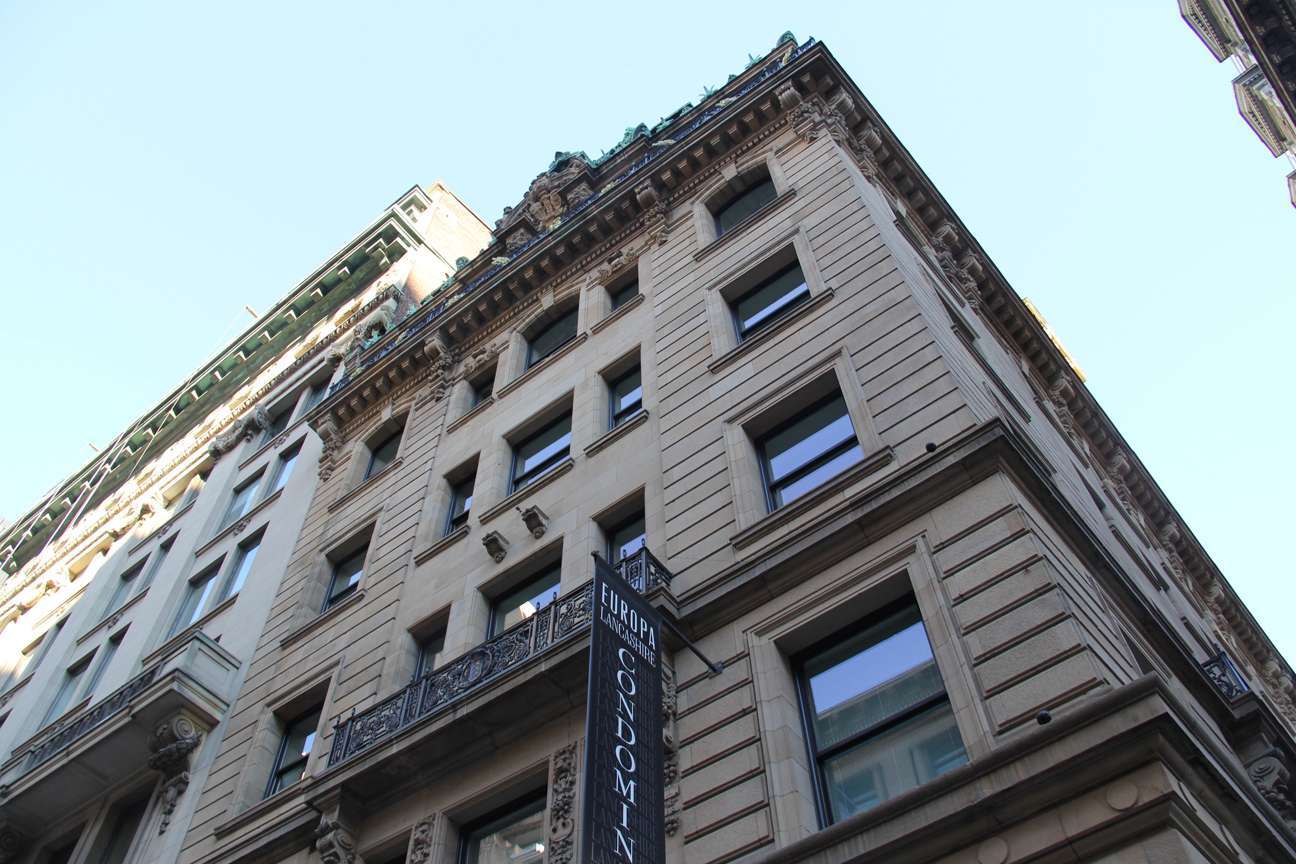 Looking up at a tall building with many windows