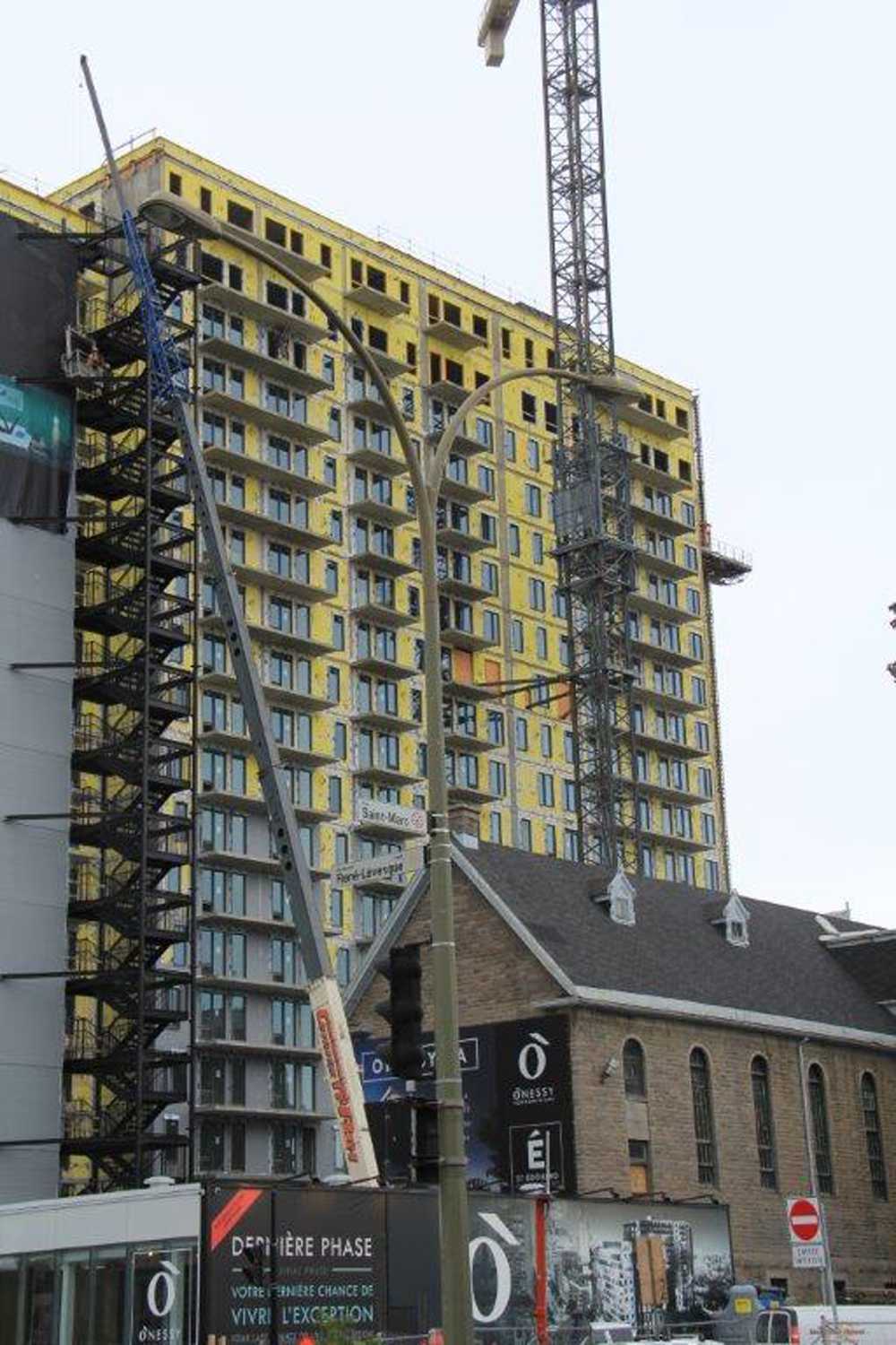 A large building under construction with a crane in the background