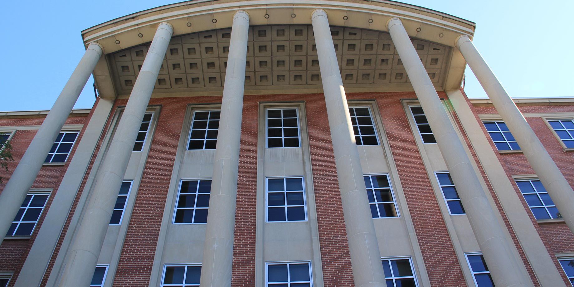 A large brick building with columns and lots of windows