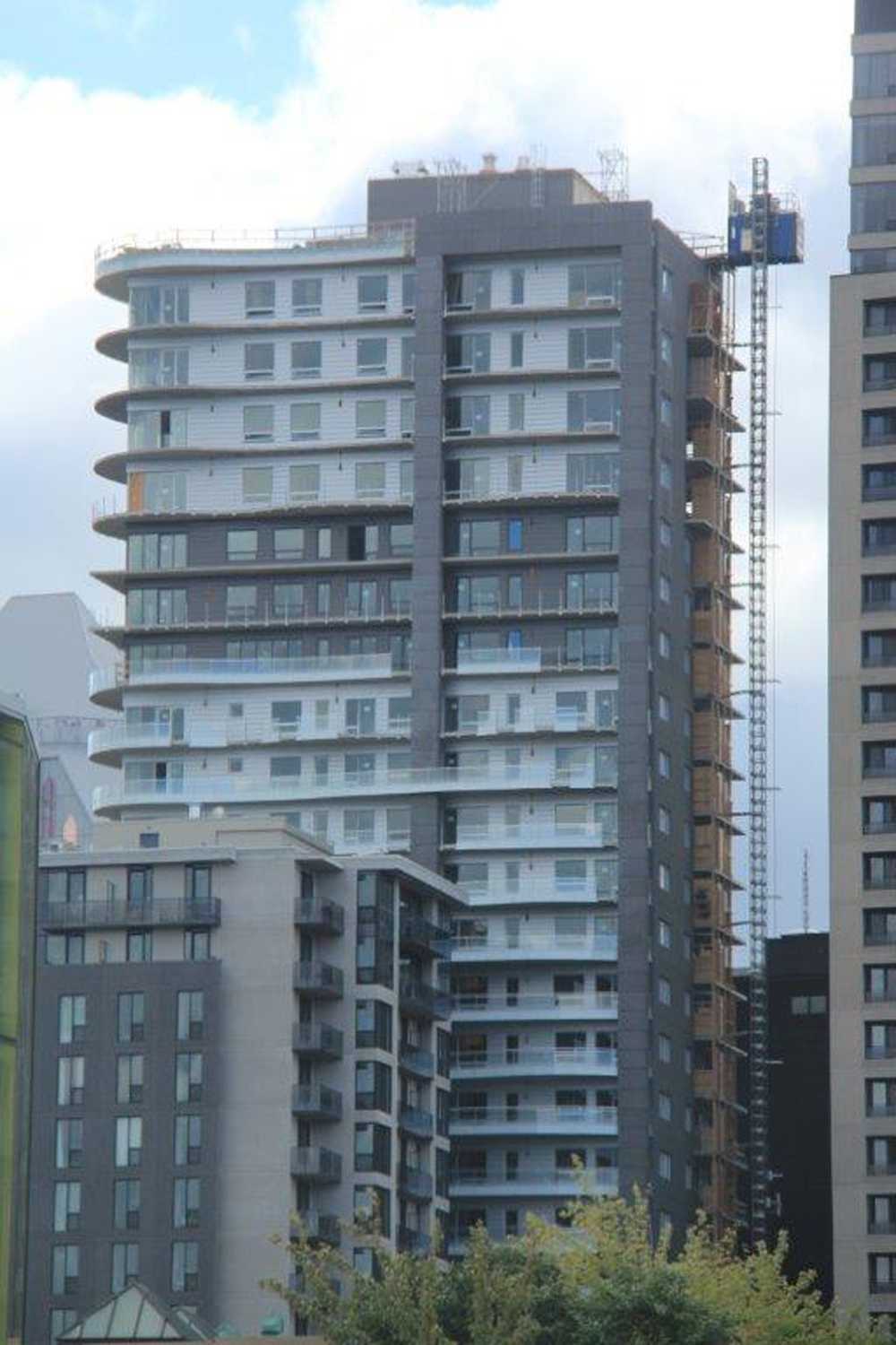 A tall building with a crane on top of it
