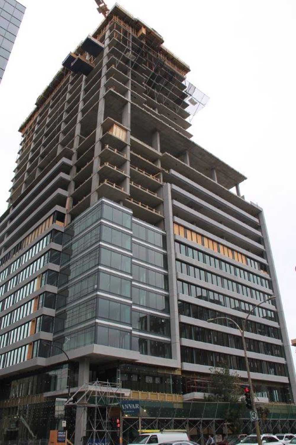 A tall building under construction with a lot of windows