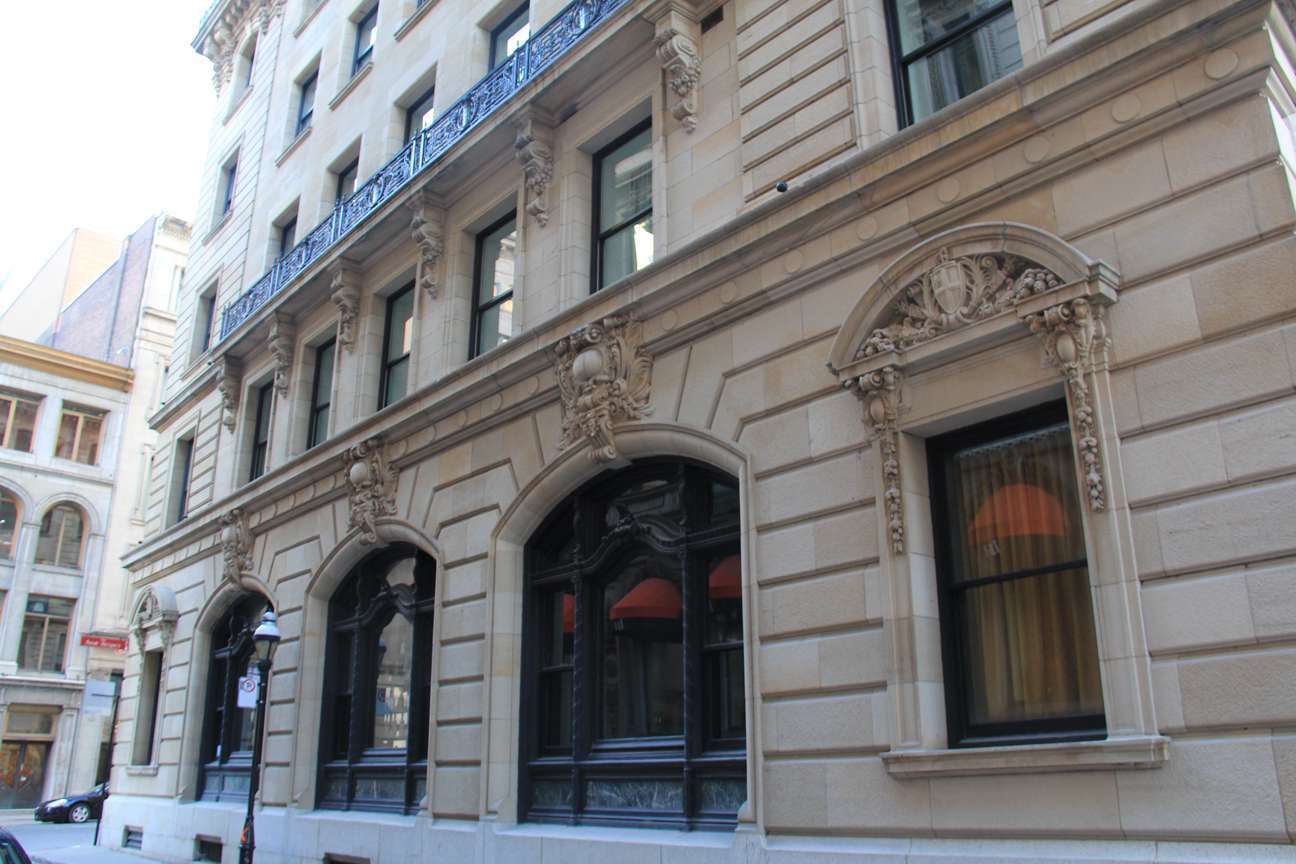 A large building with lots of windows and a blue railing