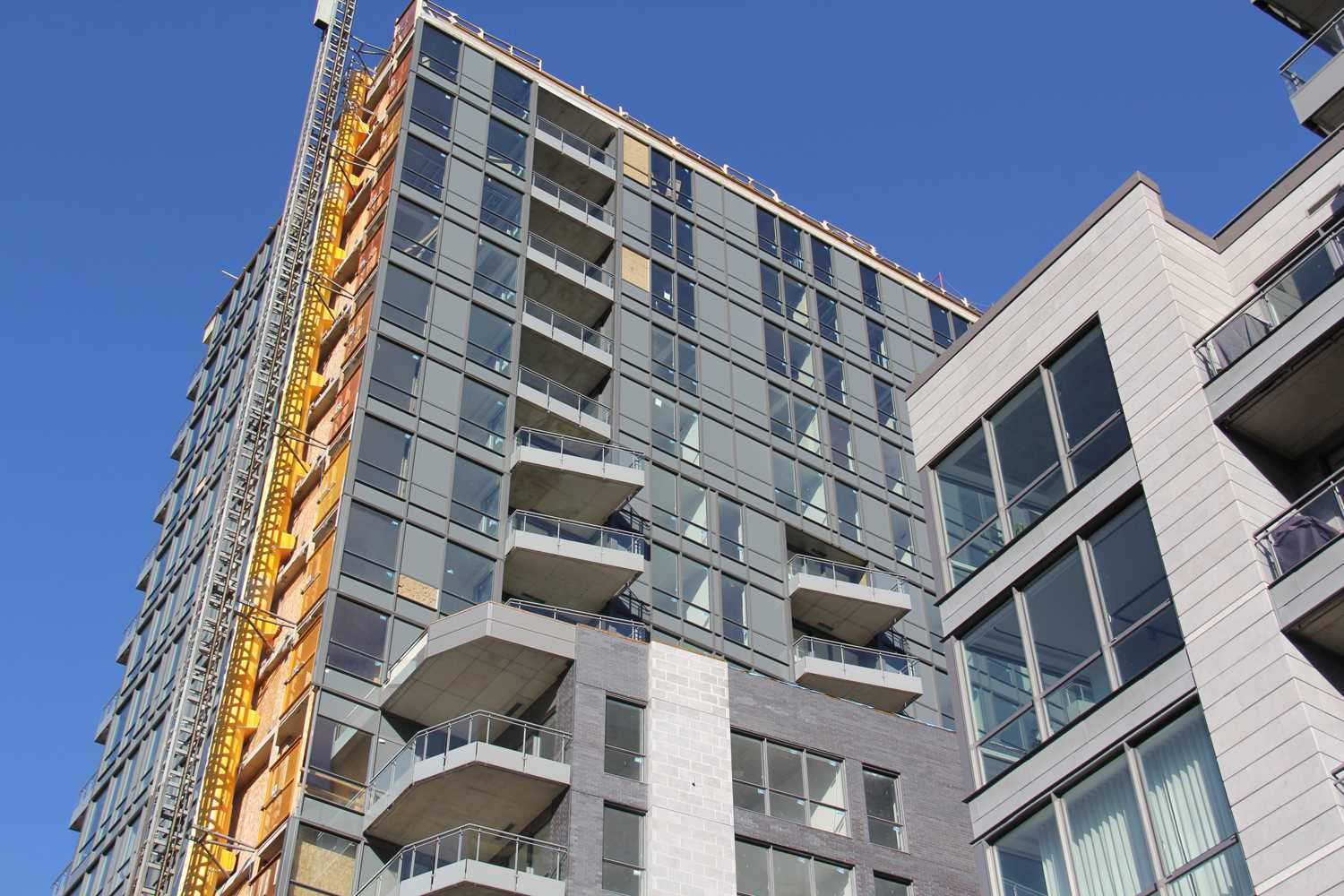 A building under construction with a blue sky in the background