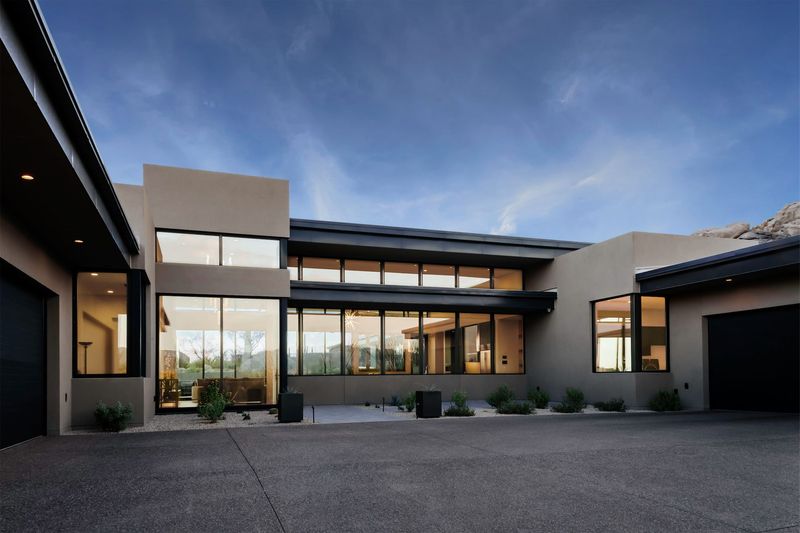 A large house with a lot of windows and a garage