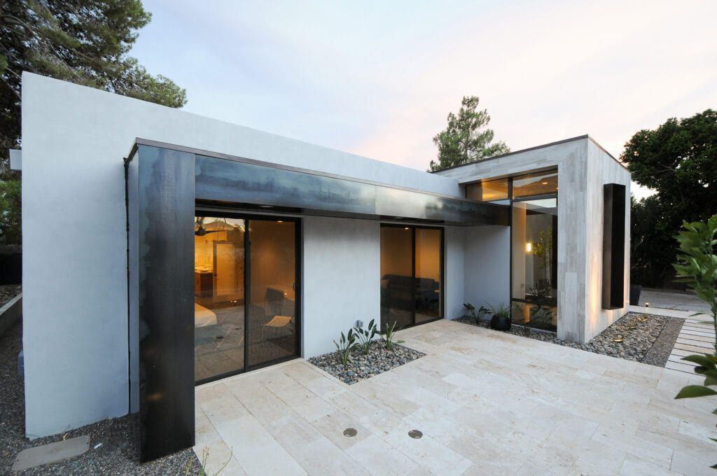 A modern house with a lot of windows and a patio