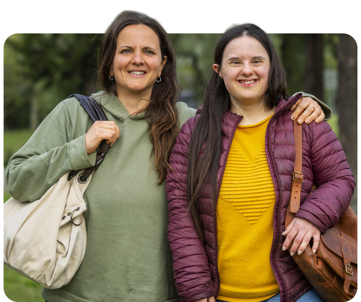Two women smiling and posing outdoors.