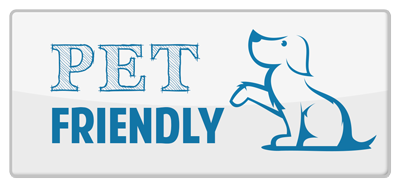 a white button with a blue dog on it that says `` pet friendly '' .