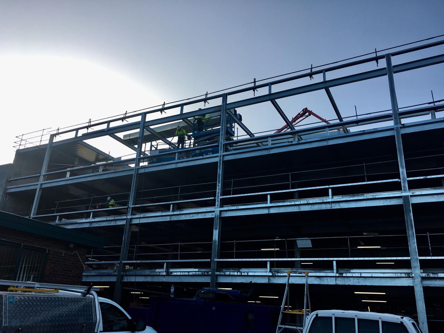 A building under construction with a blue sky in the background.
