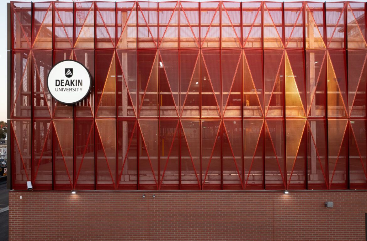 A large red building with a lot of windows and a sign on it.