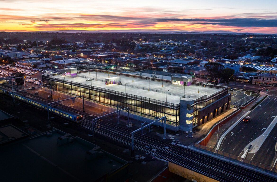 An aerial view of a large building in the middle of a city at night.
