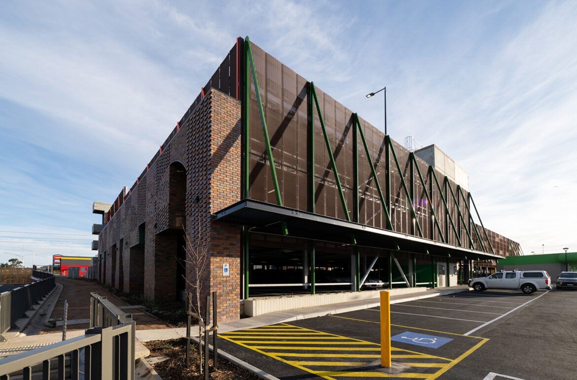 A large brick building with a parking lot in front of it.