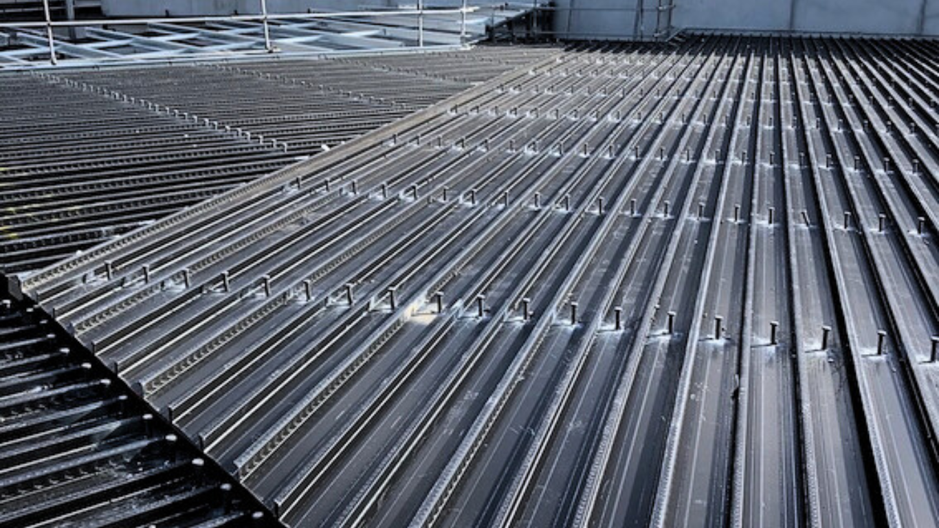 A close up of a black metal roof with a lot of lines on it.