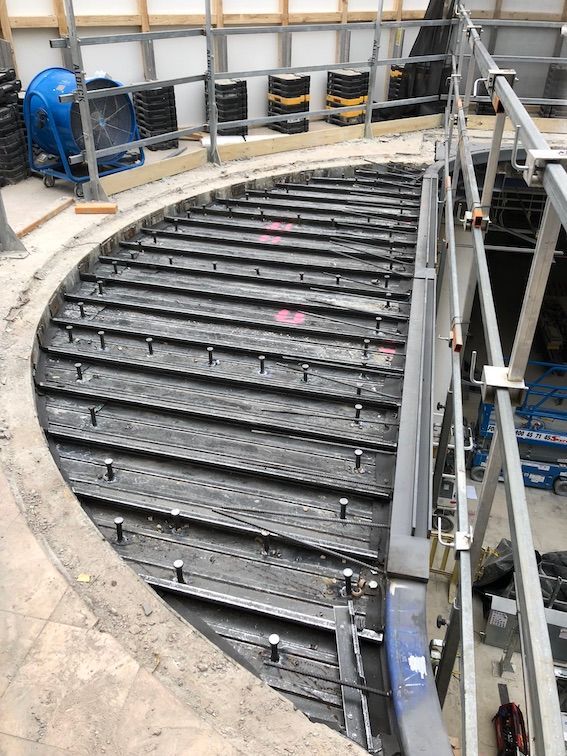 A metal staircase is being built in a building.