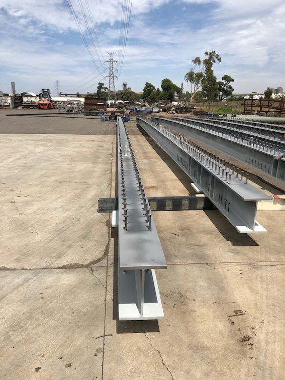 A bunch of metal beams are sitting on the ground