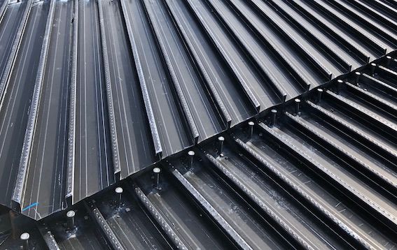 A close up of a black corrugated metal roof.