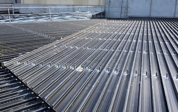 A close up of a metal roof with a railing.