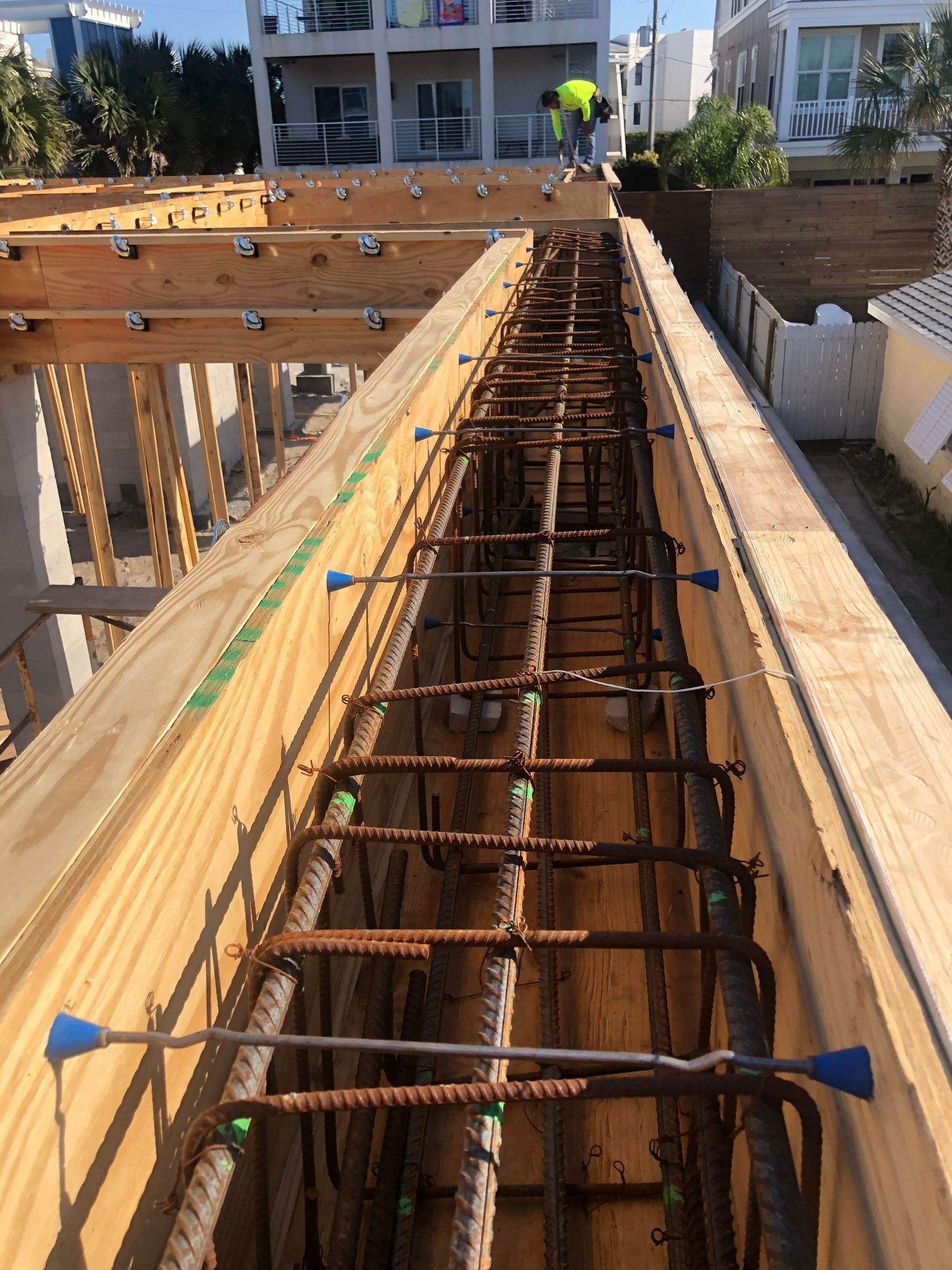 Two-story Victorian house with porch and pergola. Green siding, white trim, gray roof. Exterior setting, sunny day.