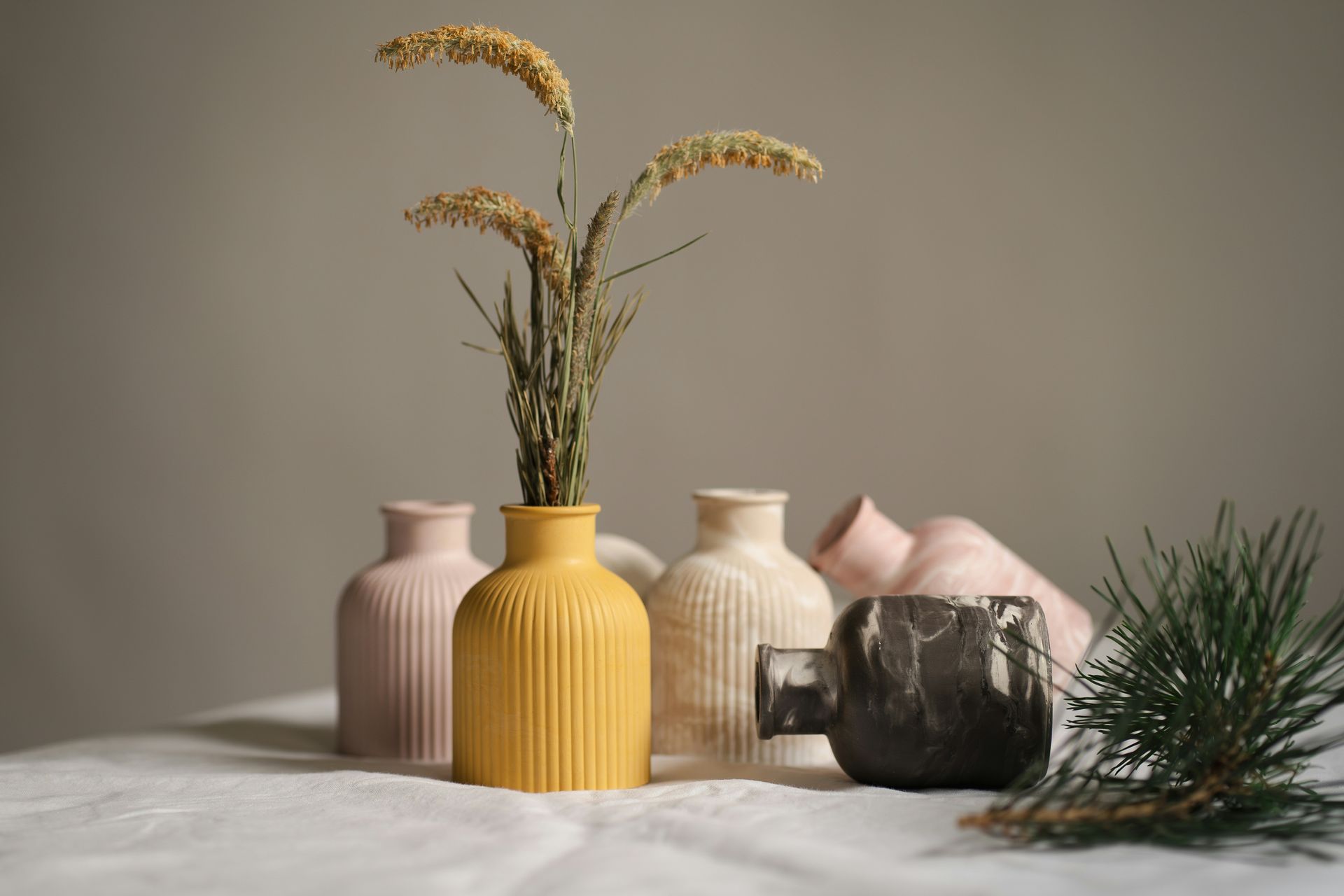 A group of vases with flowers in them are sitting on a table.