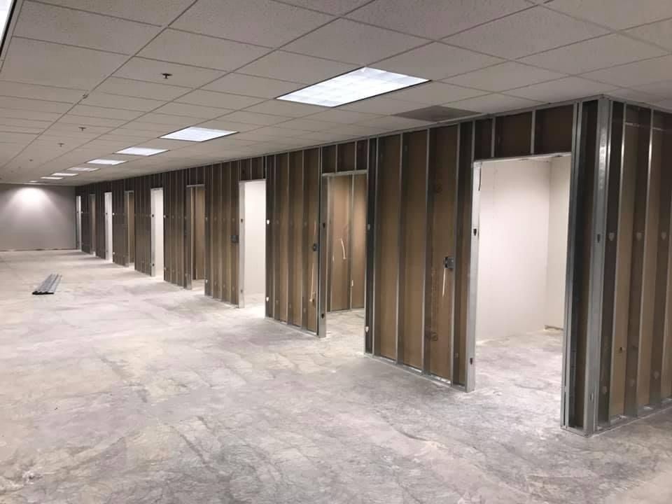 A large empty room with a lot of walls and doors.