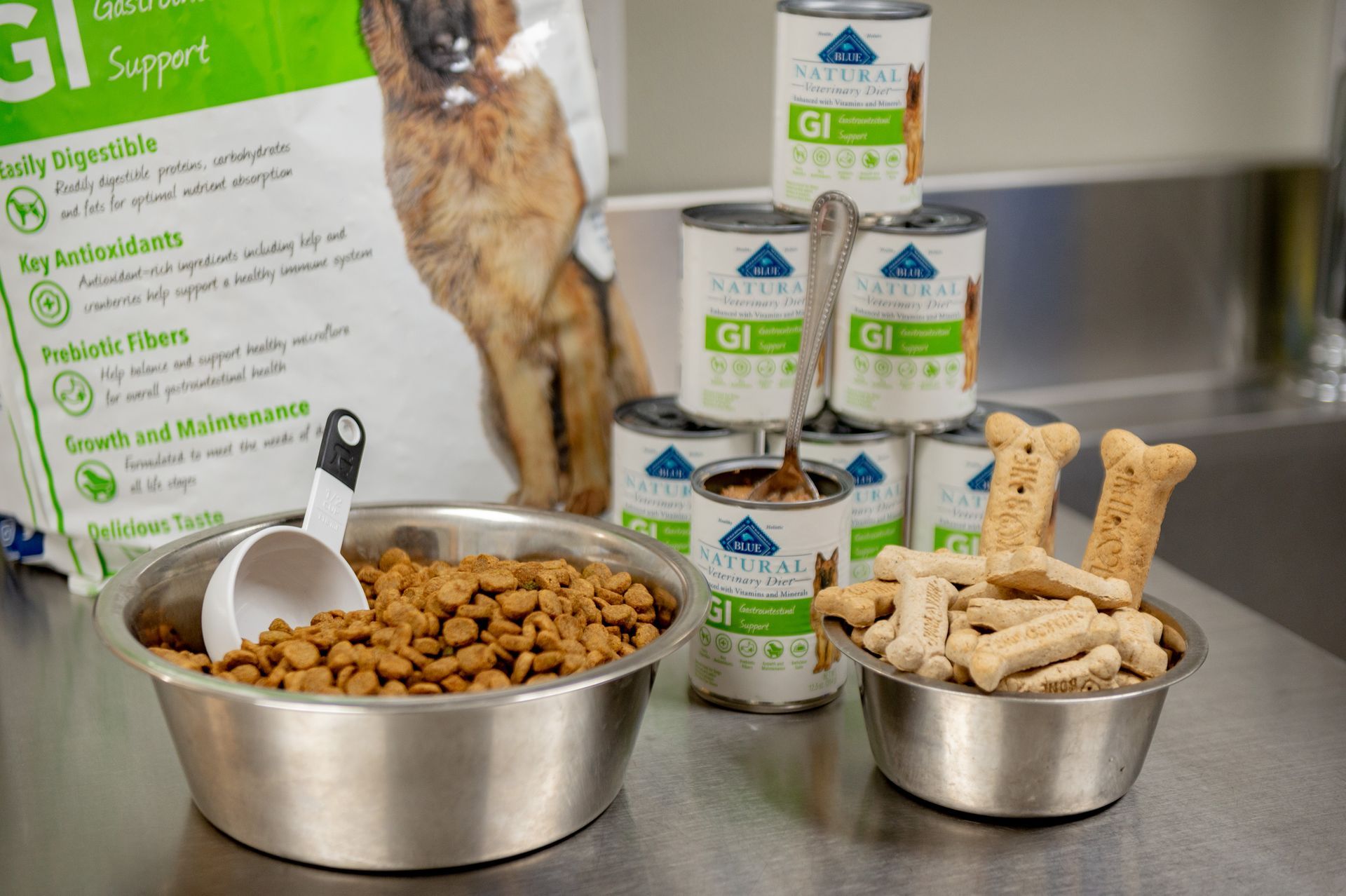 A bowl of dog food and a bowl of dog treats on a table.