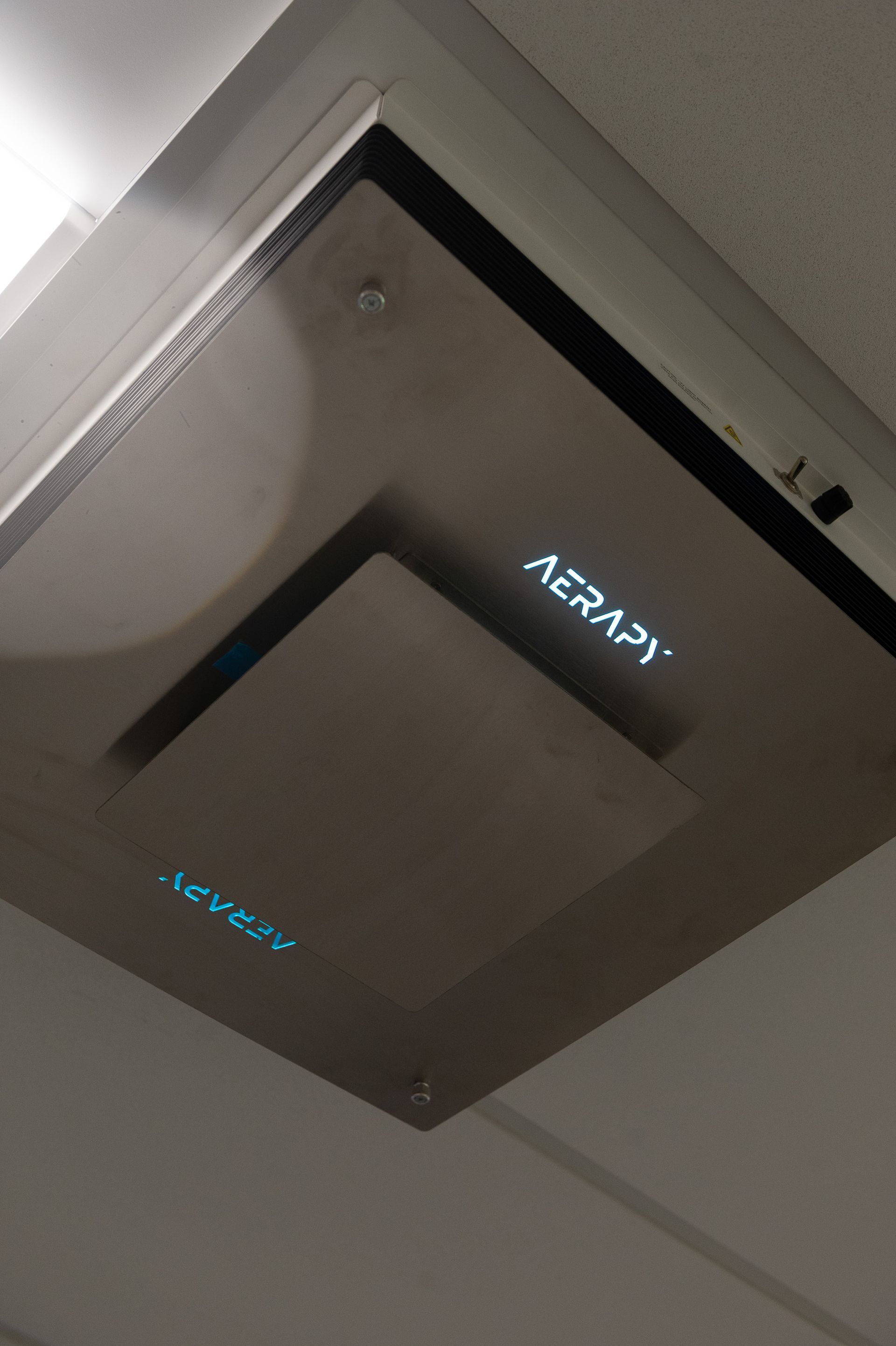 A ceiling mounted device that says acap on it