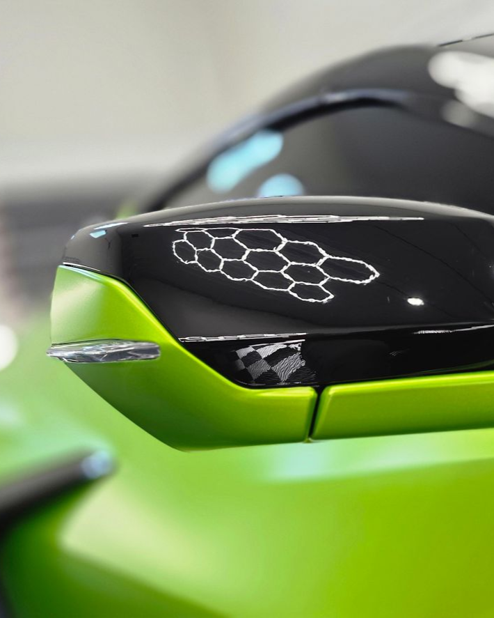 Red Chevrolet pickup truck with black wheels and a tinted windshield parked on asphalt.