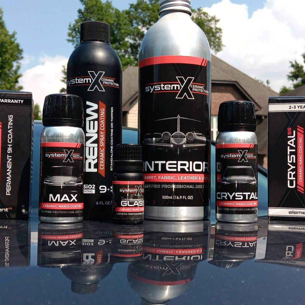 Several bottles of renew and crystal products are sitting on top of a car