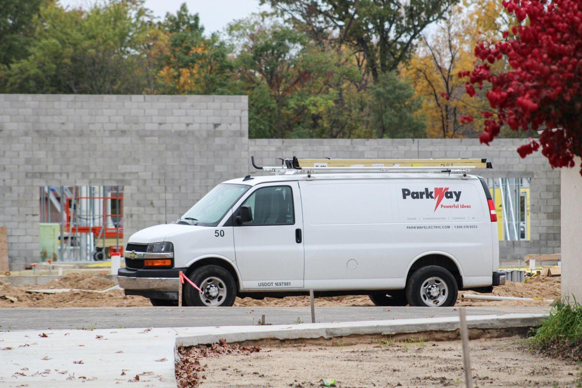 Parkway van parked at construction site.