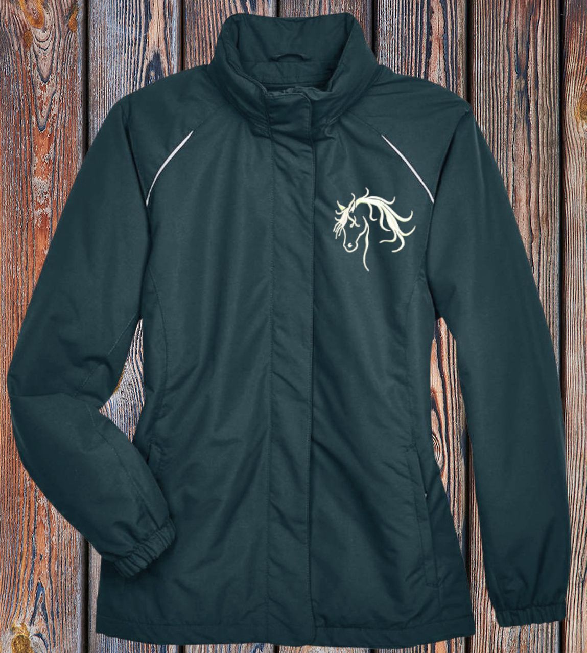 Woman wearing a button-down shirt with a repeating horse print; the shirt is open over jeans.