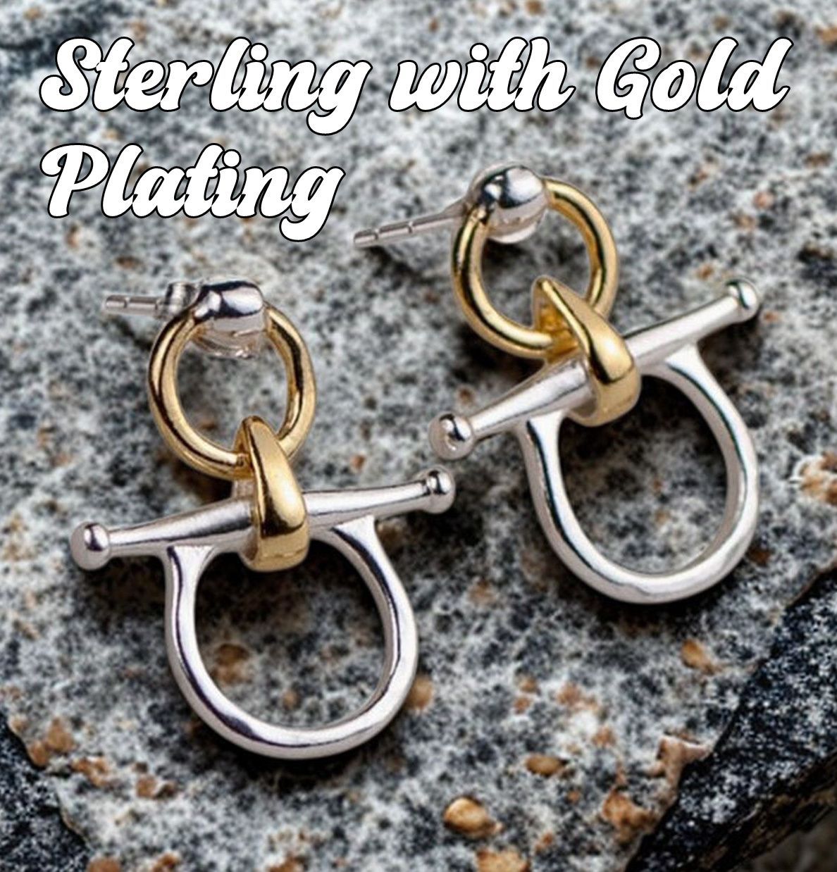 Wooden horse earrings with silver hooks on a stone surface.